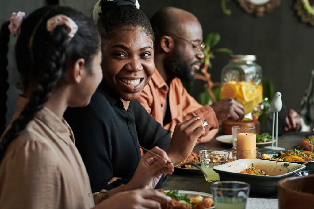 Happy woman sitting at family dinner